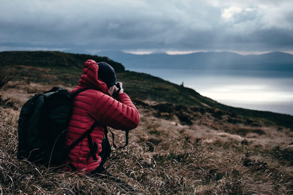 A man photographs a cloudy landscape